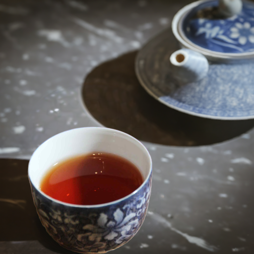 2009 Qi Zi Ancient Tree Ripe Pu-erh Tea in a tea cup