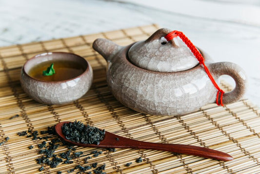 Pu-erh tea in pot and cup with pu-erh leaves