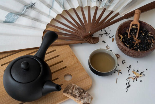 Pu-erh tea in cup with pu-erh leaves