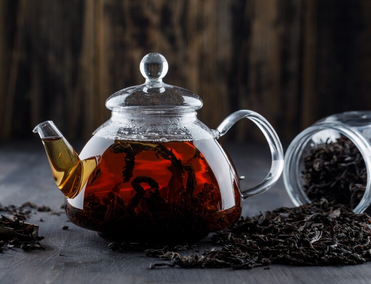 Green tea in pot with leaves