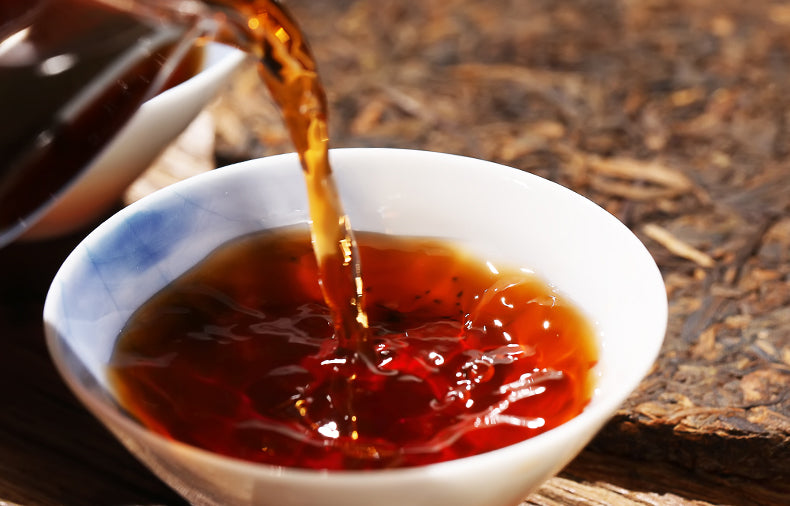 A chinese cup filled with 2009 Tea-Horse Road Pu-erh Ripe Tea